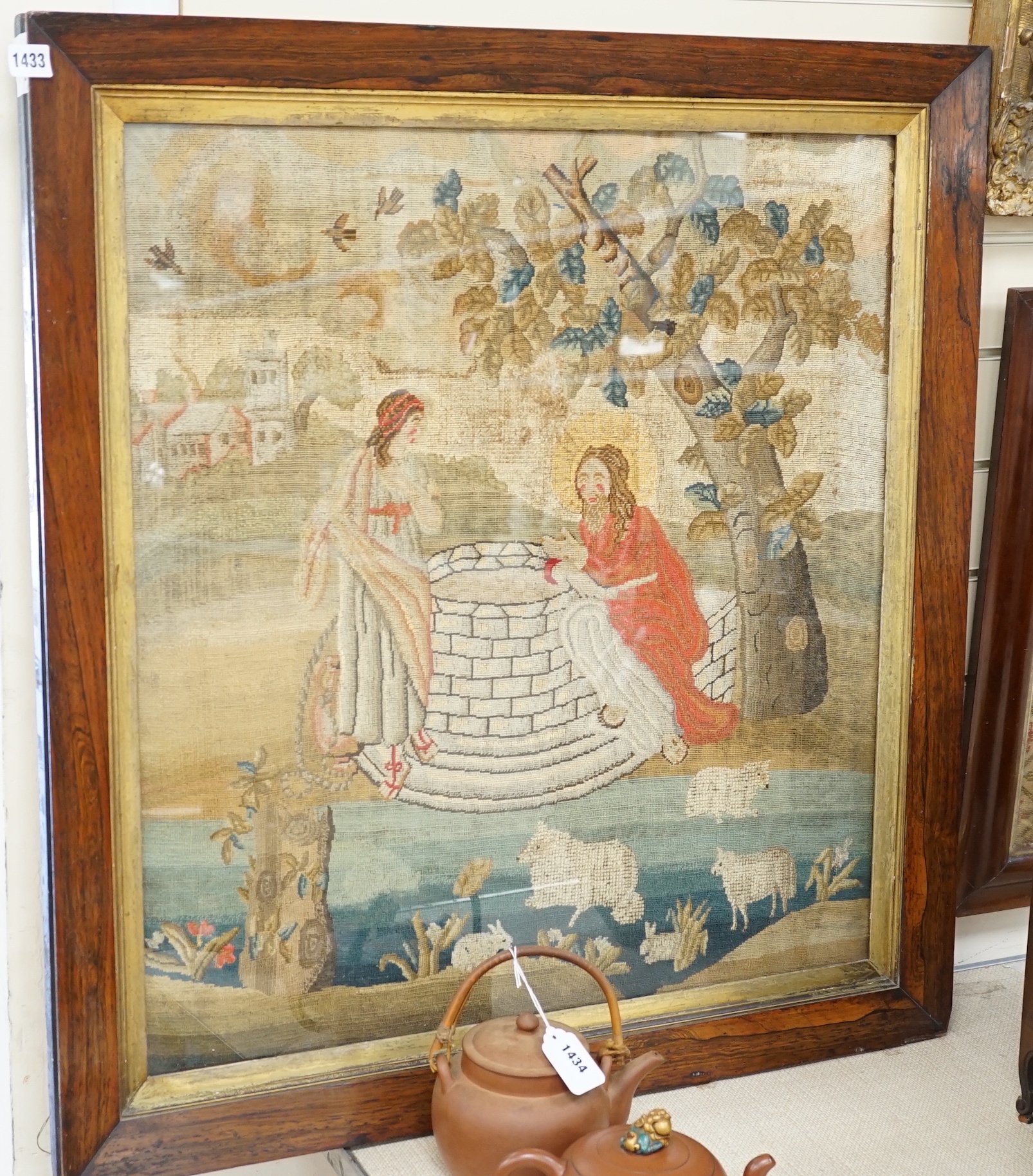 An early Victorian woolwork picture of Christ and the Samaritan widow at the well, 71x65cm, in rosewood frame
